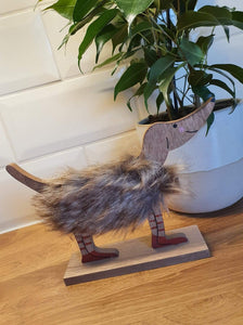 Fluffy Wooden Dog with Red Boots .